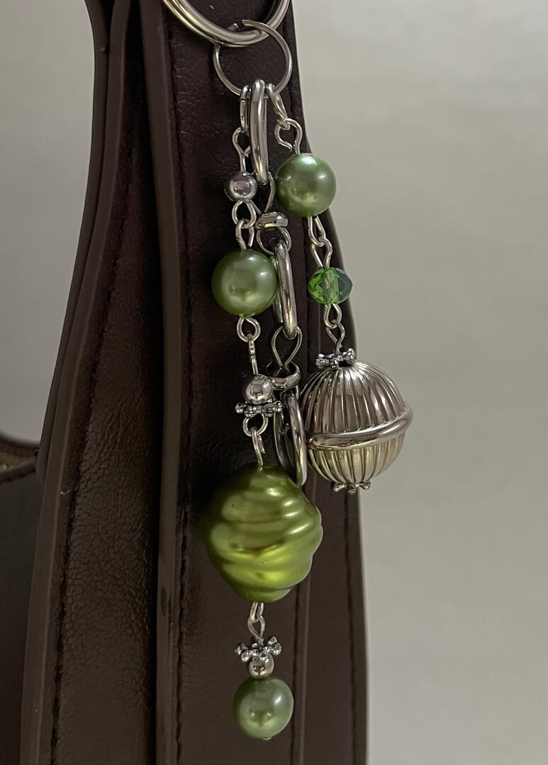 Silver and green bag charm